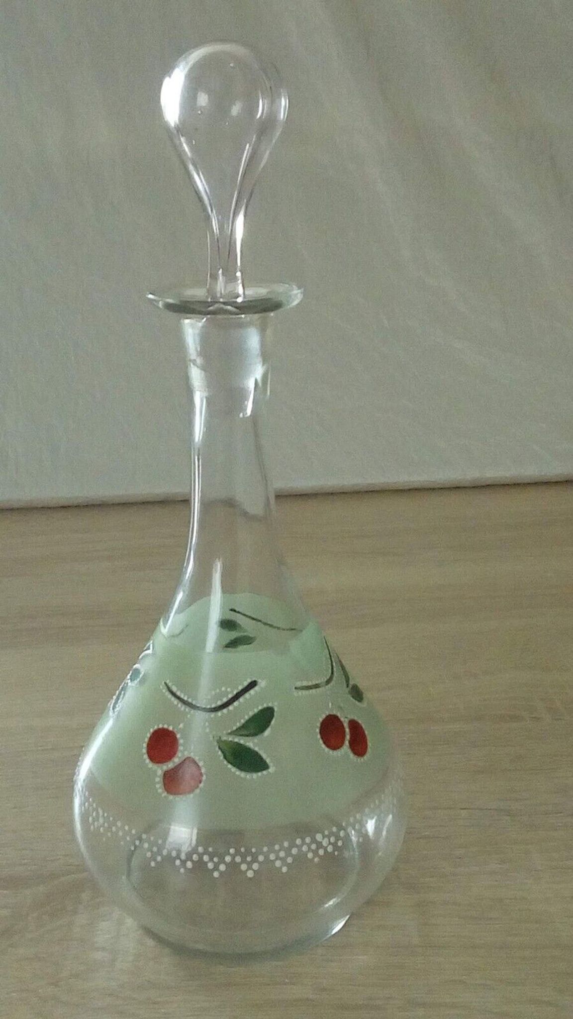 Glass carafe with enamel decoration of cherries.
