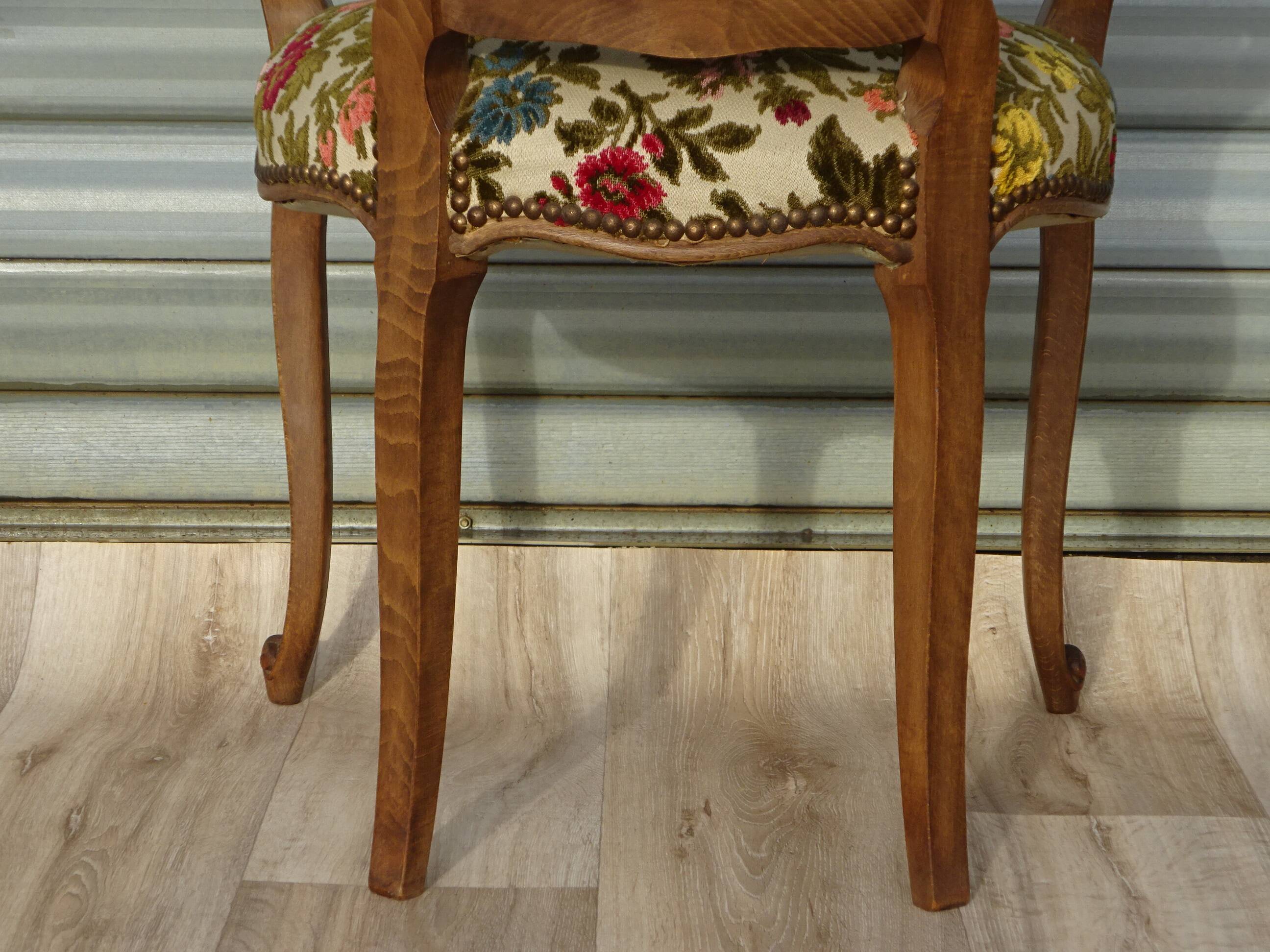 Convertible armchair with brocade fabric and floral patterns.