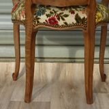 Convertible armchair with brocade fabric and floral patterns.