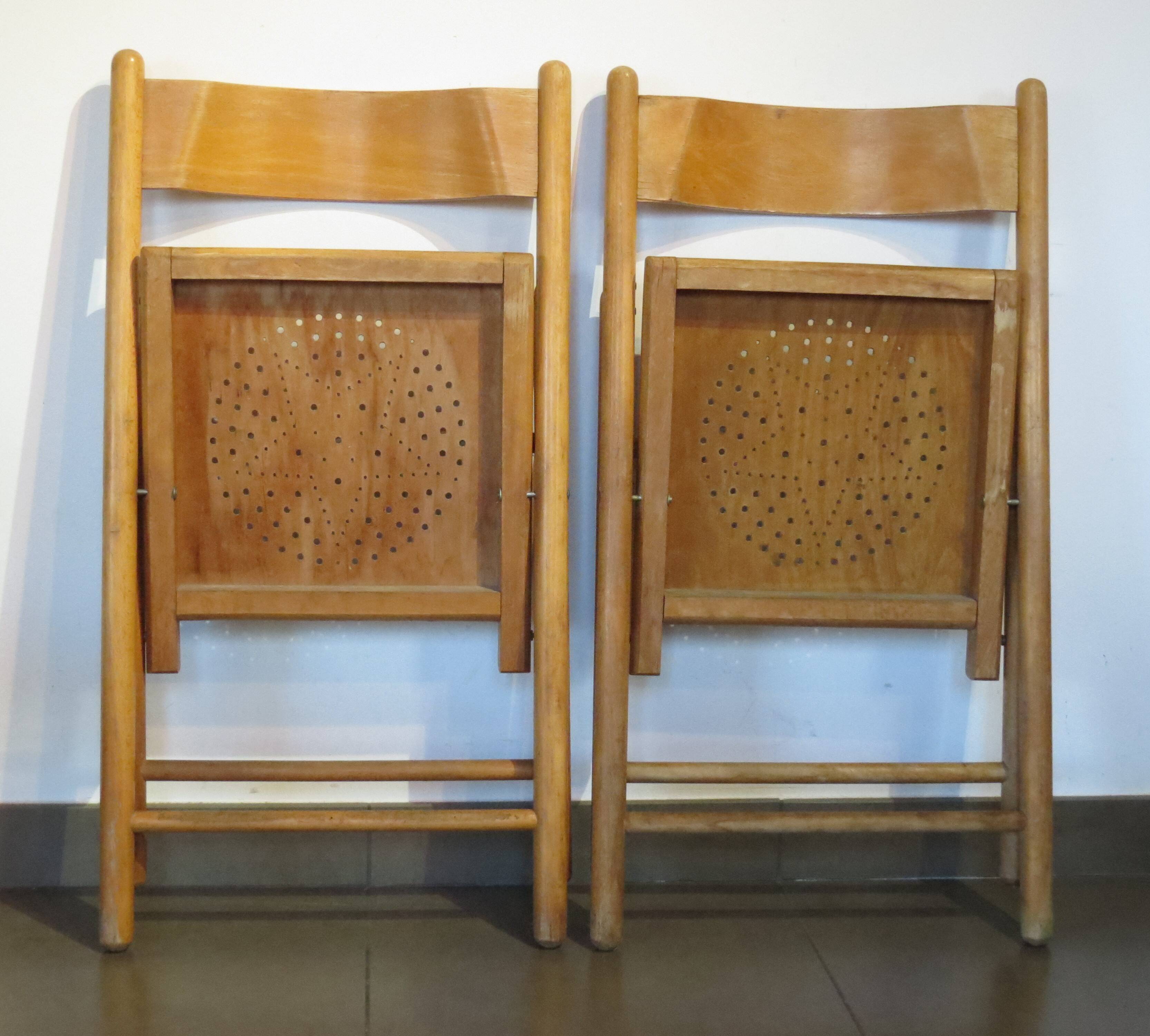 Pair of vintage wooden folding chairs with star pattern on seat