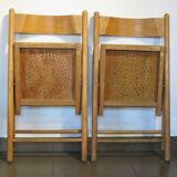 Pair of vintage wooden folding chairs with star pattern on seat