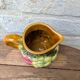 Small jug, milk pot in slipware with relief fruits Salins les Bains