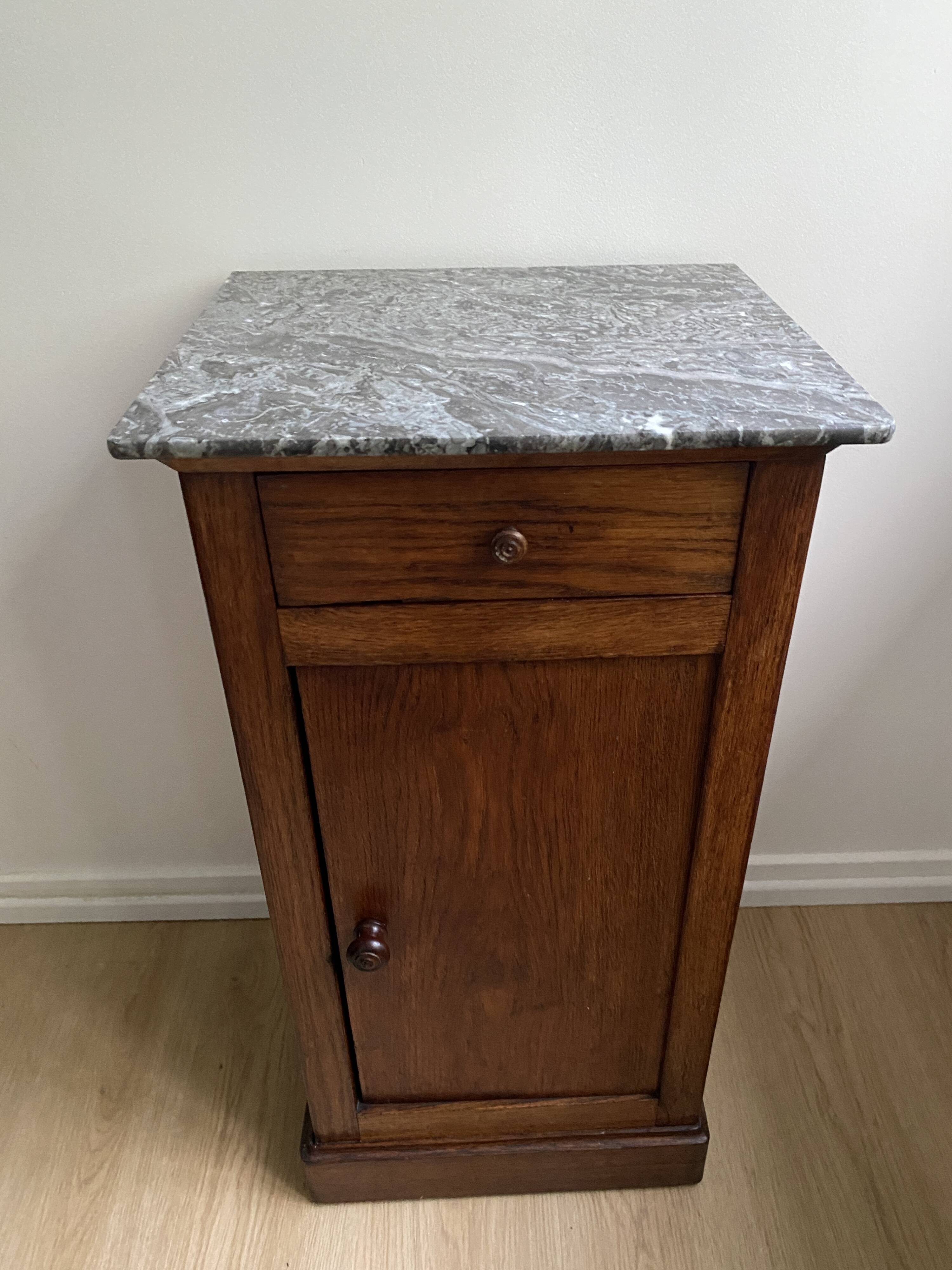 Vintage bedside table in the shape of a wooden column and a gray marble top
