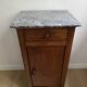 Vintage bedside table in the shape of a wooden column and a gray marble top