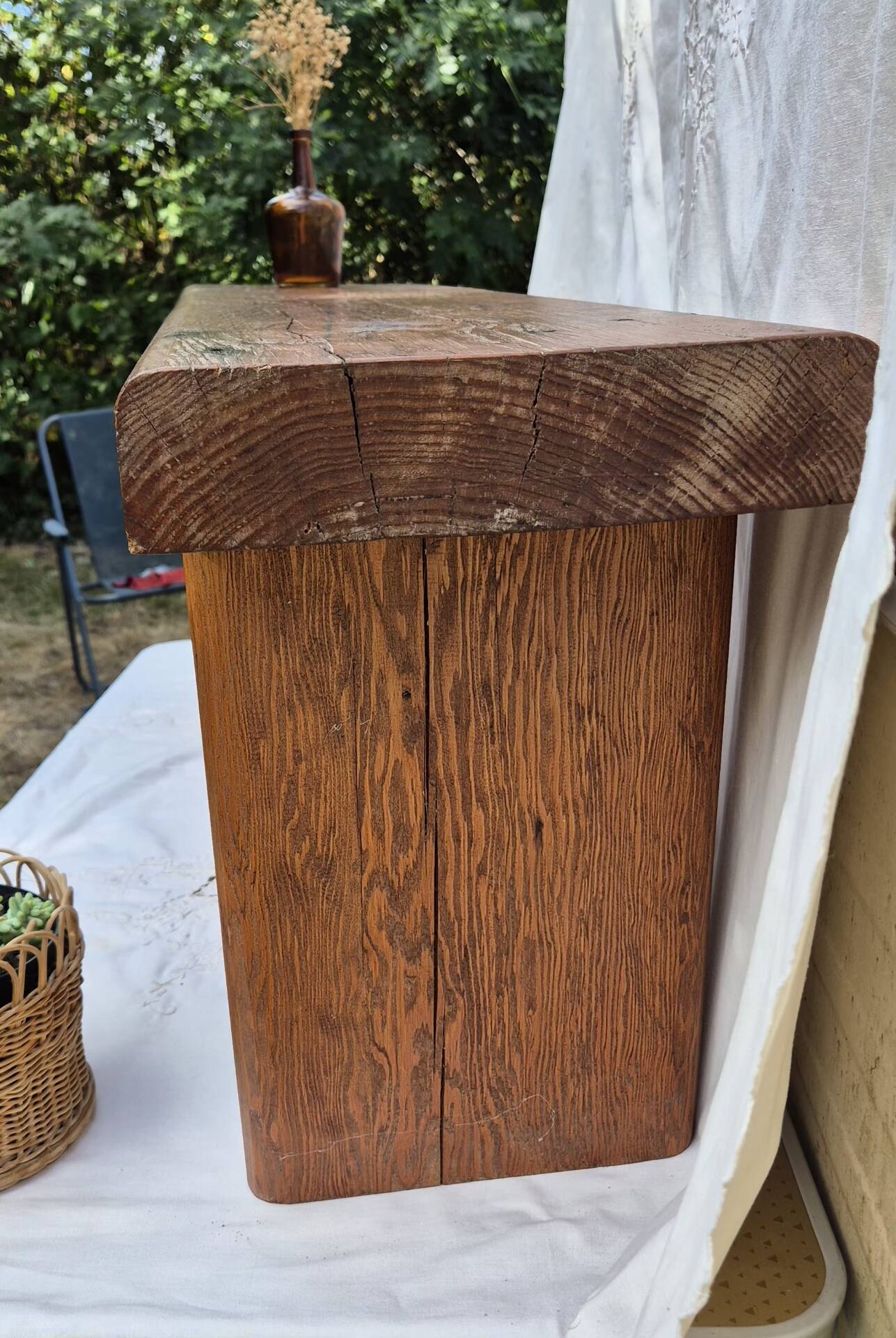 Brutalist wooden bench made of solid oak beam.
