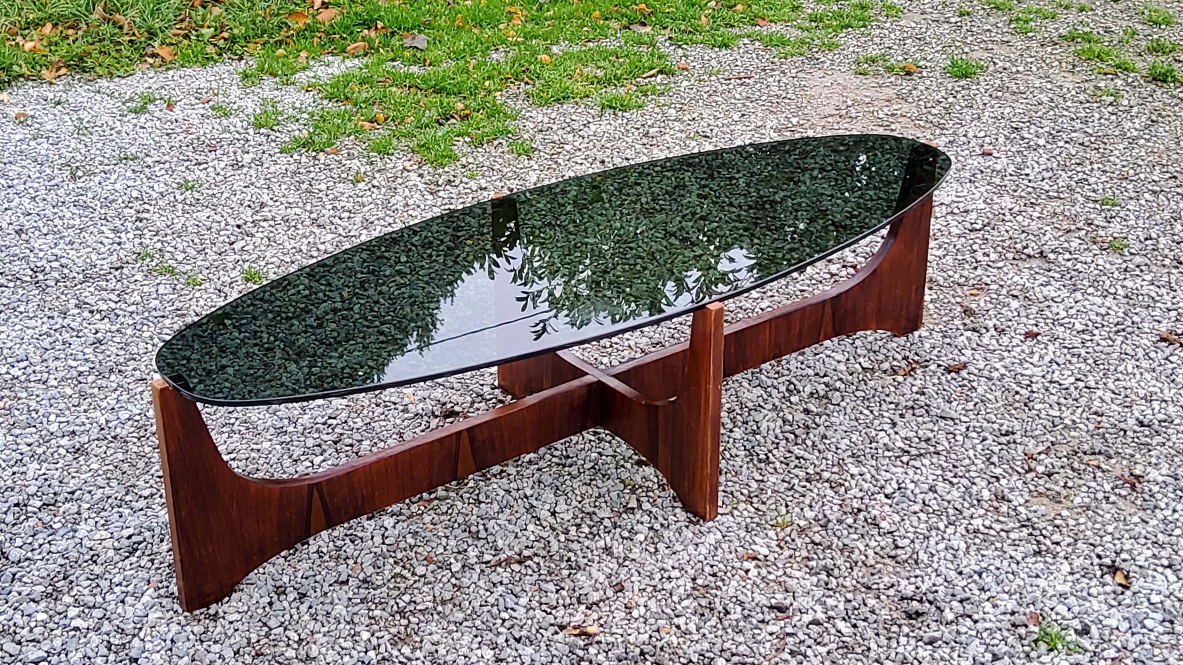 Designer coffee table by Hugues Poignant in rosewood and smoked glass from the 70s