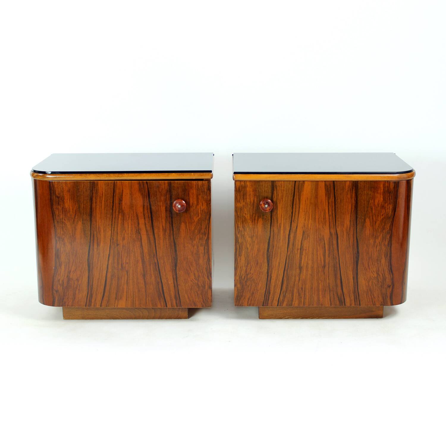 Pair of Art Deco bedside tables in walnut and black glass, Czechoslovakia.