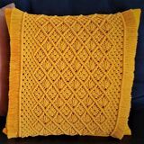 cushion and its macramé adornment