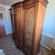 Large English-style wardrobe with a curved front and three doors.