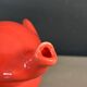 Large coral-coloured elephant teapot.