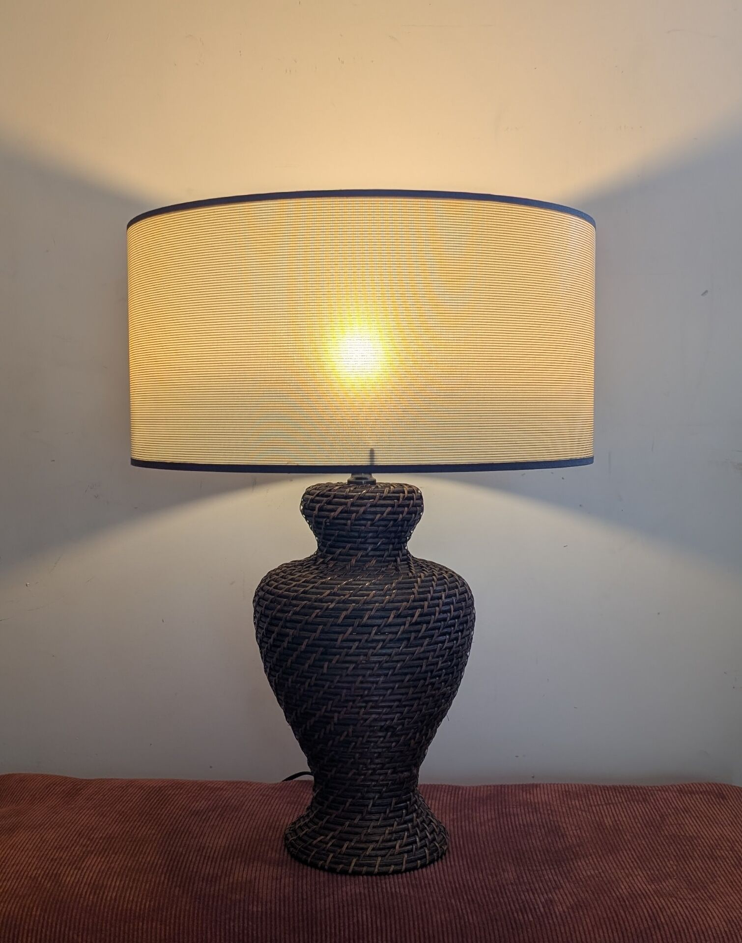 Vintage lamp in brown rattan with textured lampshade.
