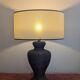 Vintage lamp in brown rattan with textured lampshade.
