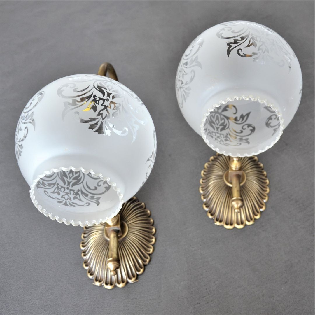 Pair of engraved glass wall lamps, brass support