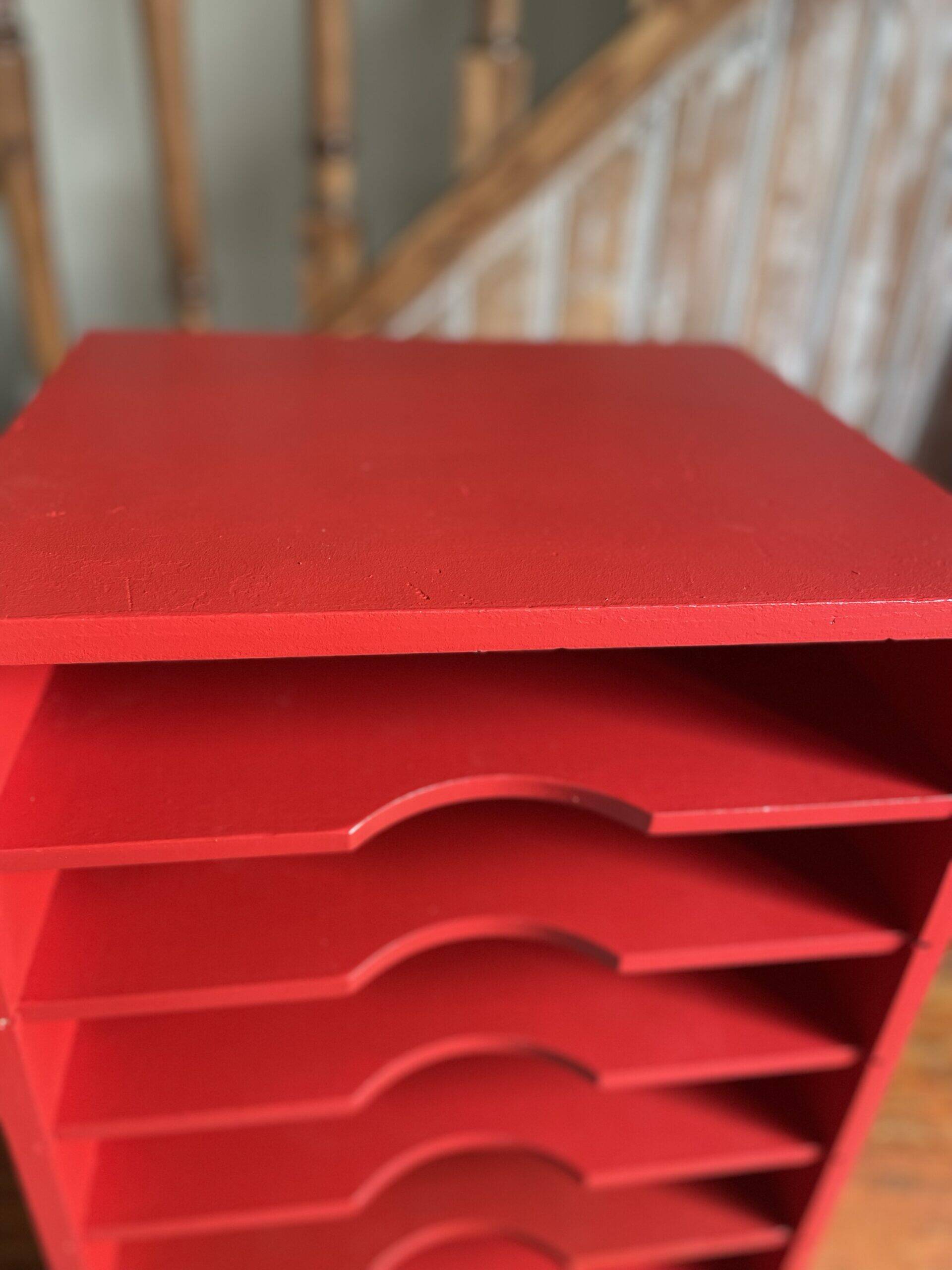 Vintage wooden magazine rack in red.