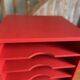Vintage wooden magazine rack in red.