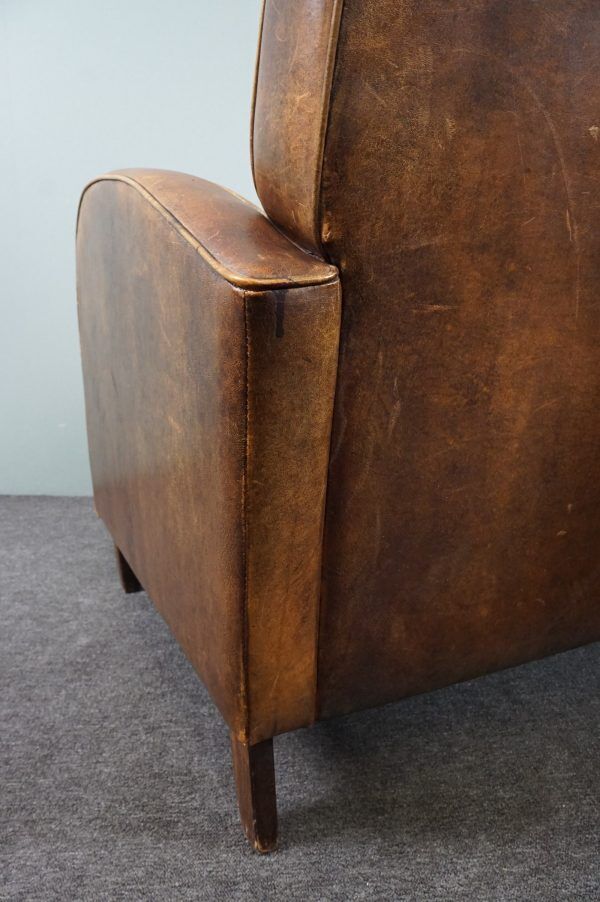 Paire de fauteuils en cuir de mouton