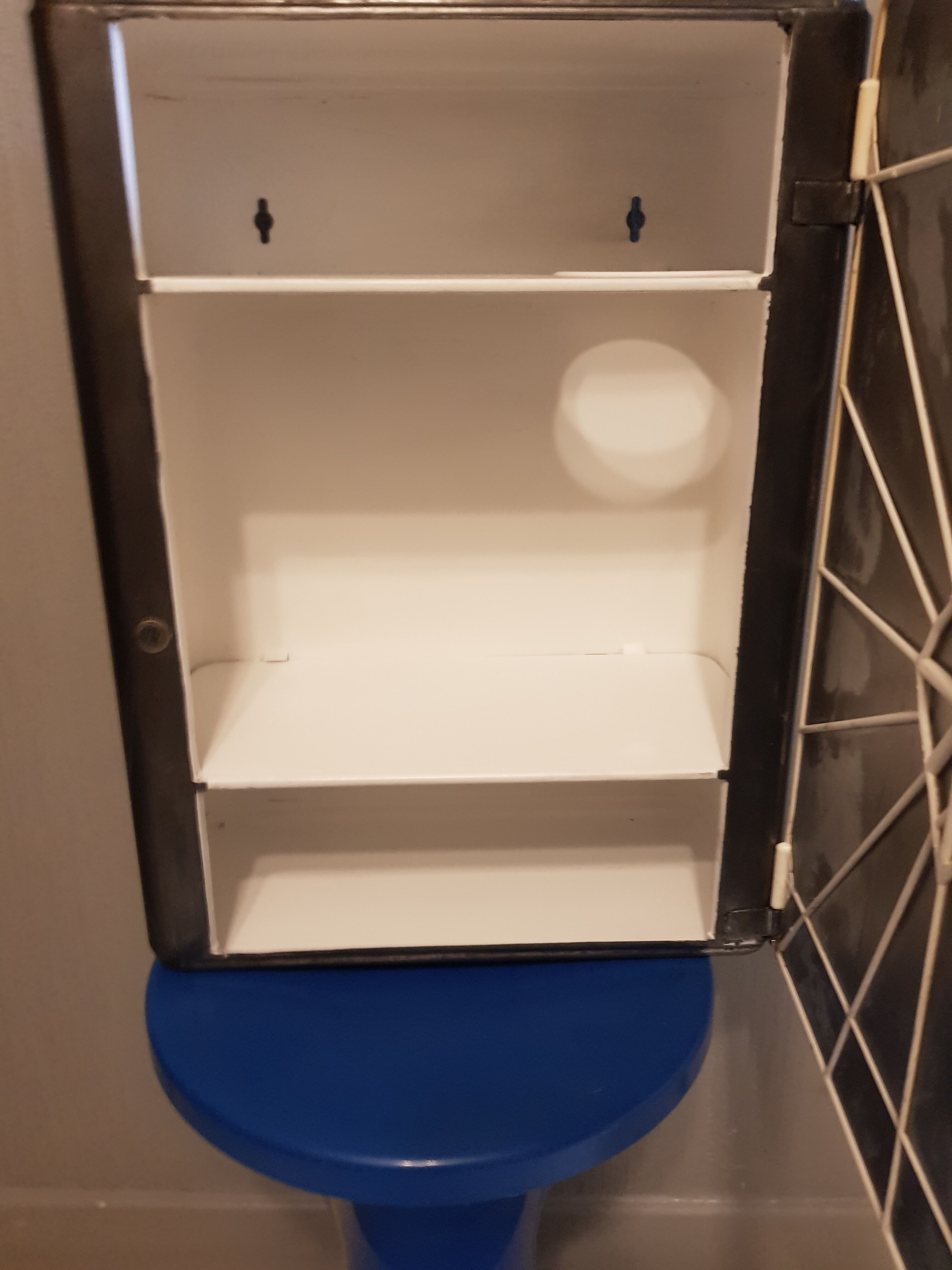 Vintage wax metal medicine cabinet.