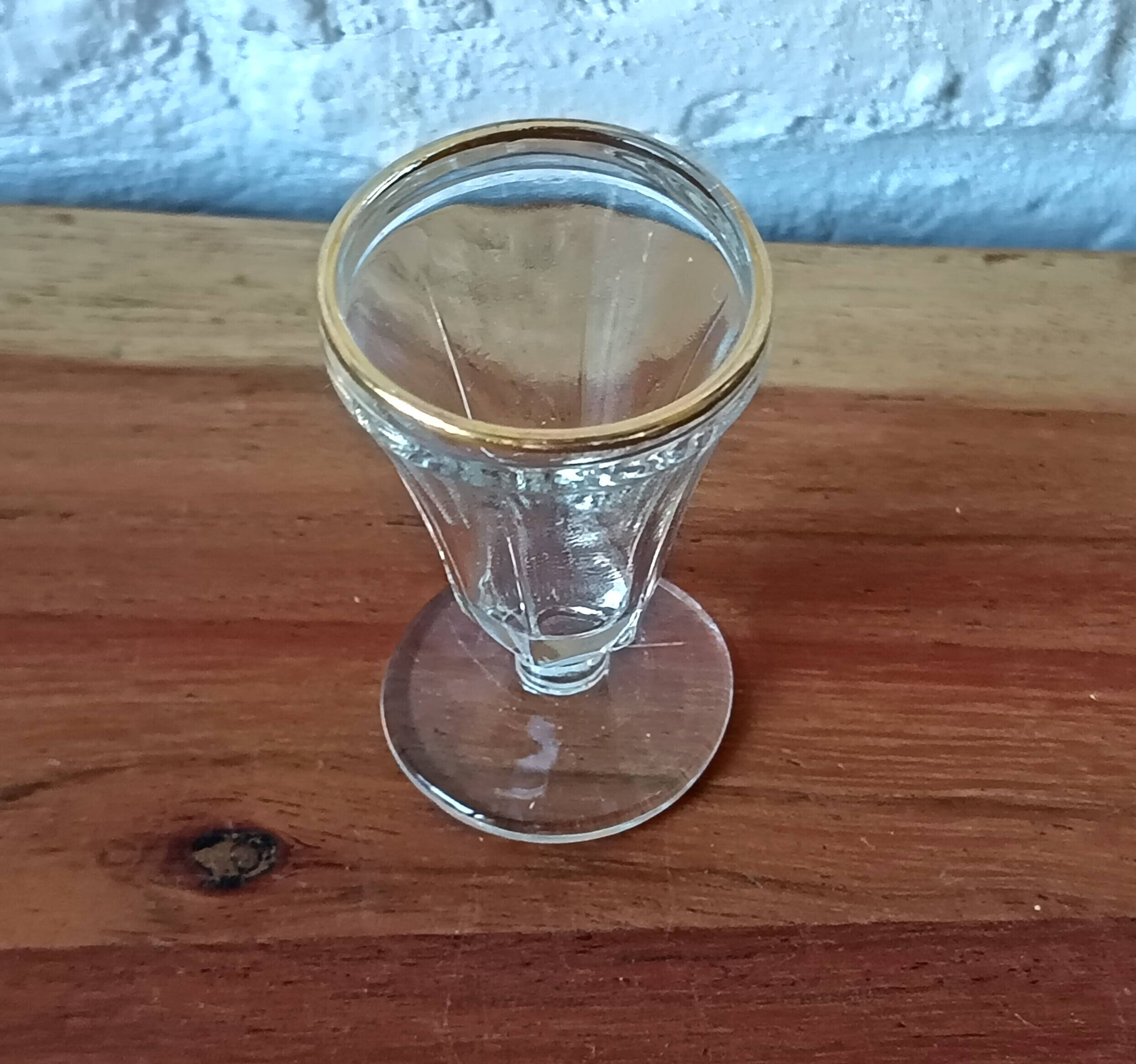 Antique footed liqueur glasses with gold trim from the early 20th century.