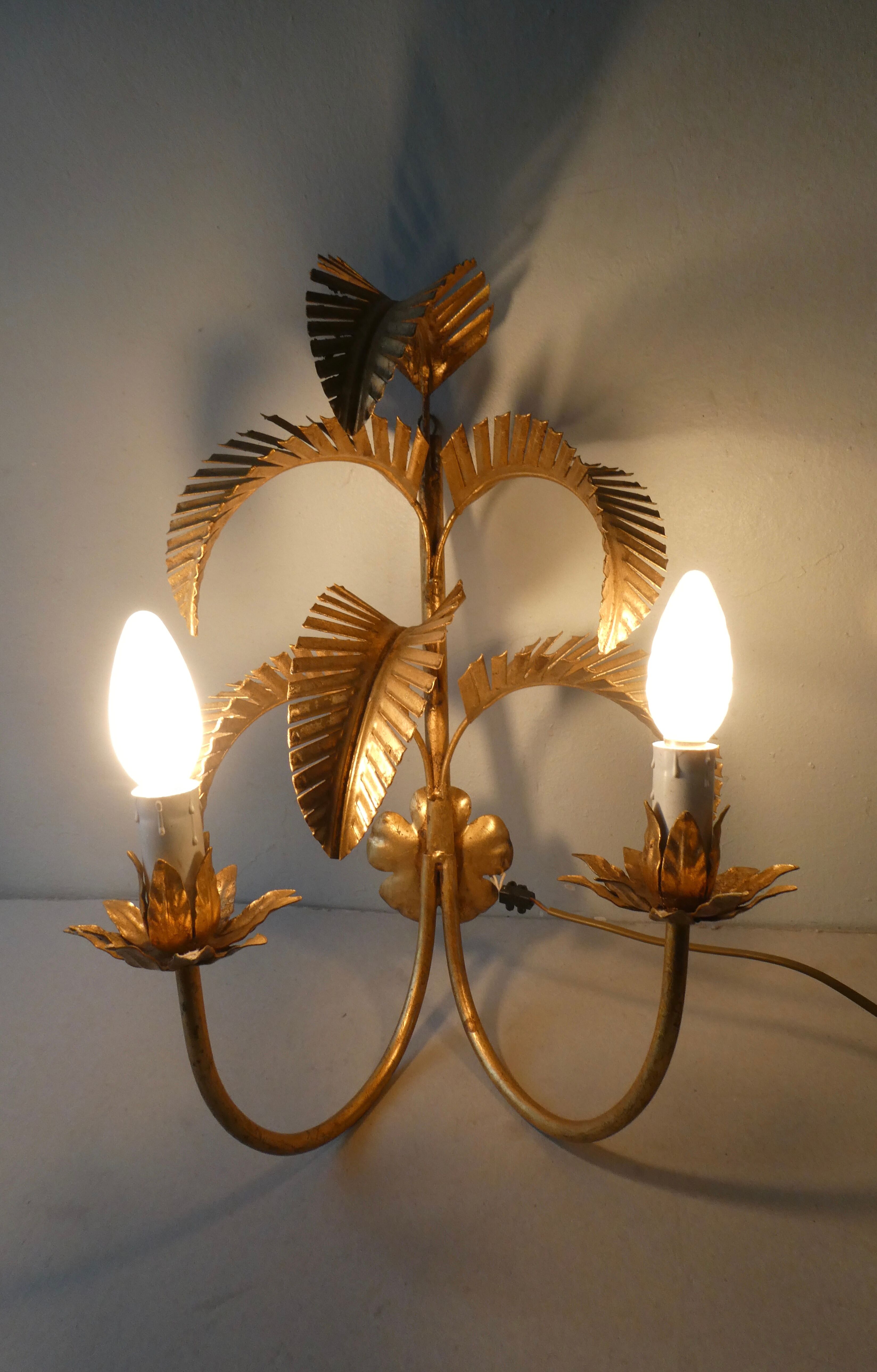 Pair of gold metal palm sconces, 70s