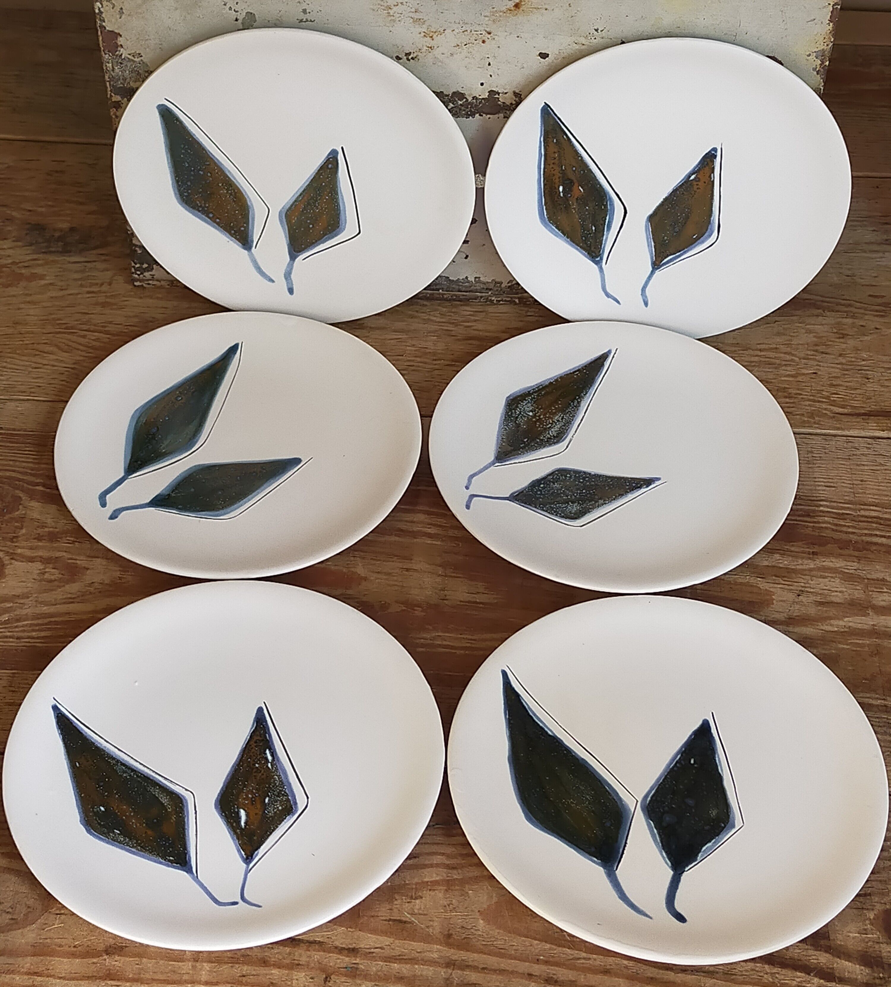 Six ceramic plates with matt enamel 50s
