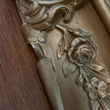 Large antique baroque mirror with angel decorations.