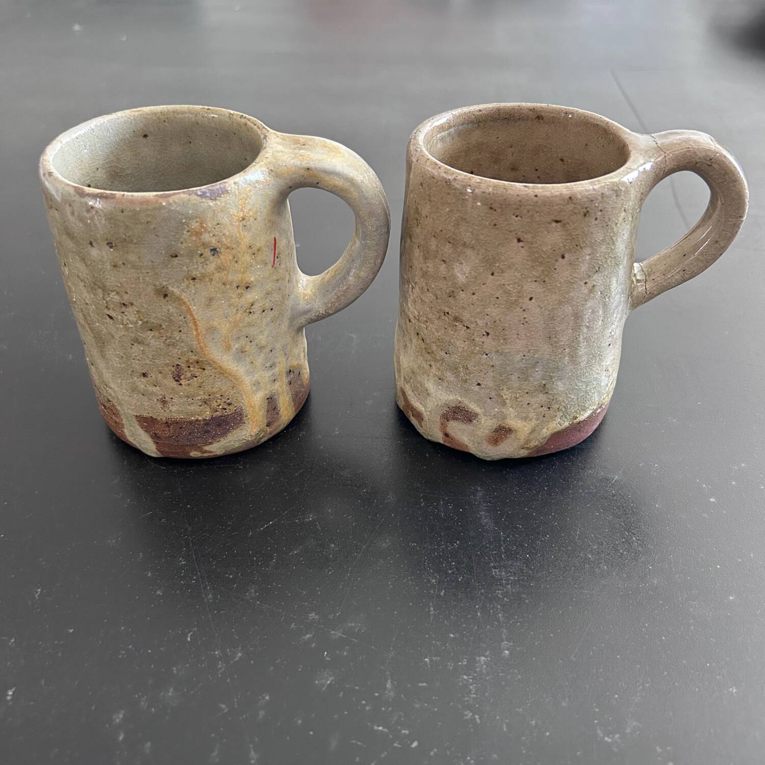 Pair of signed stoneware mugs