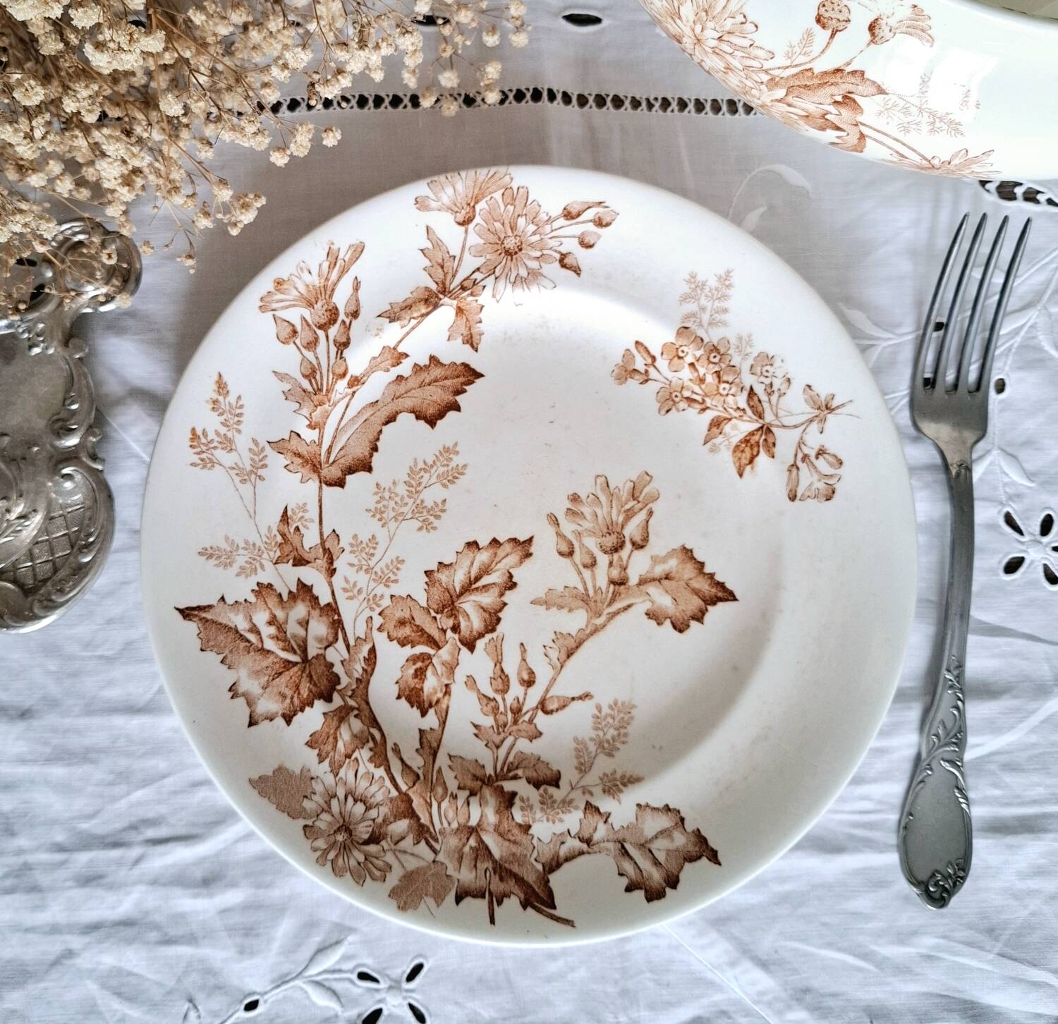 Antique iron earthenware plates accompanied by dishes