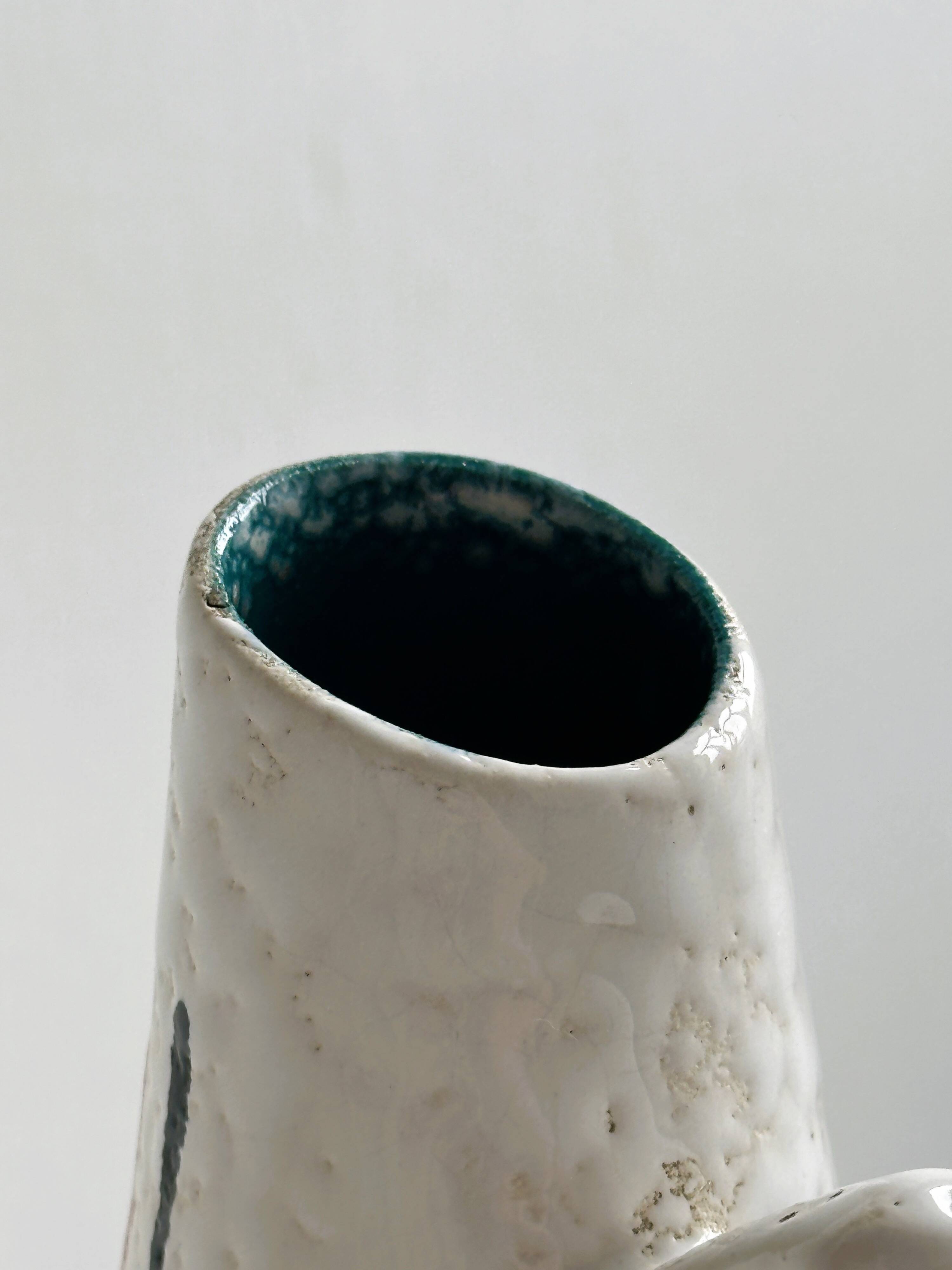 Ceramic pitcher with hand painted floral pattern