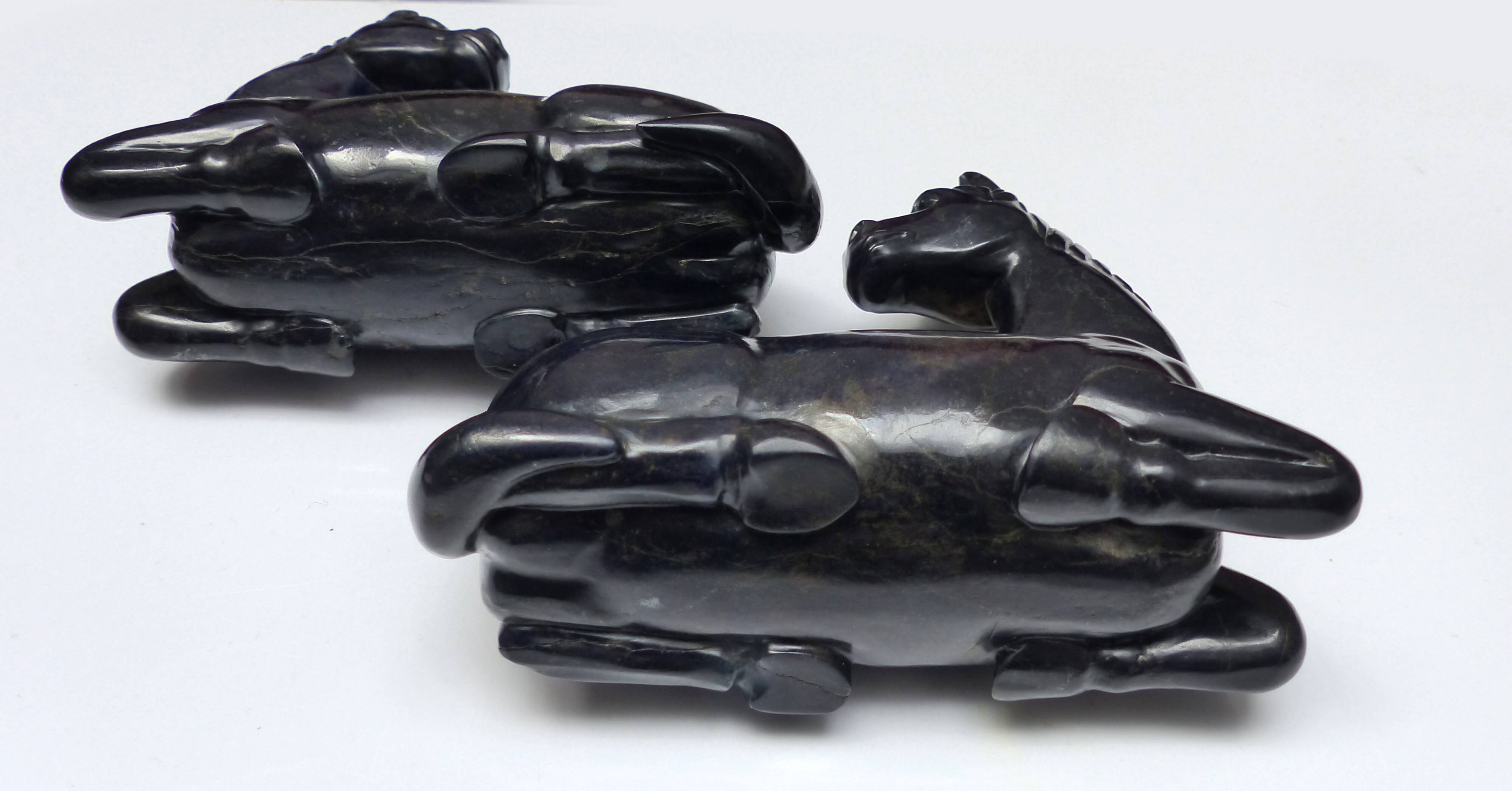 Black marble bookends with lying horses