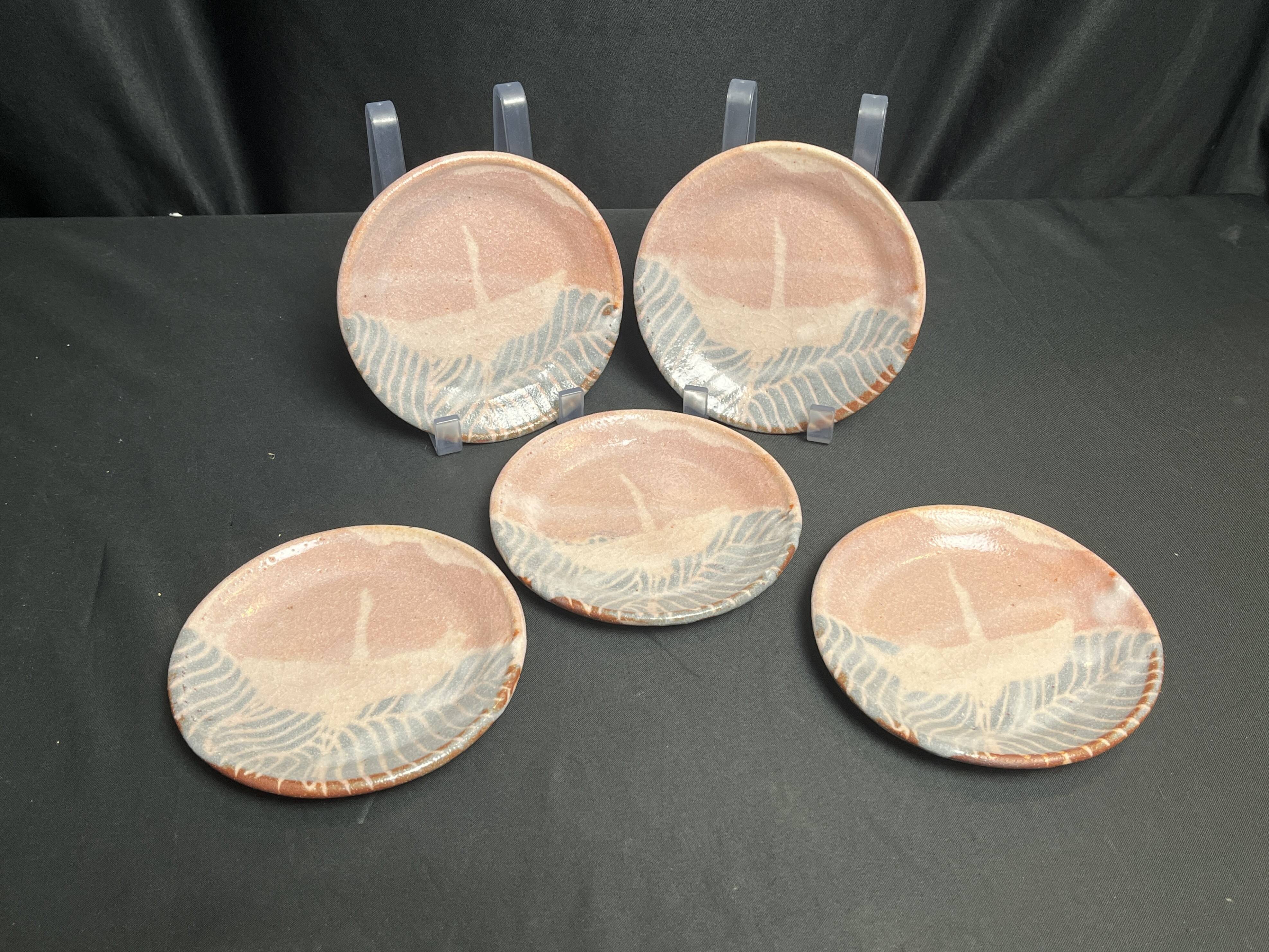 Set of five small Korean stoneware plates with pink crane, 20th century