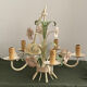 Five-branch enamelled metal chandelier with pink flower decoration.