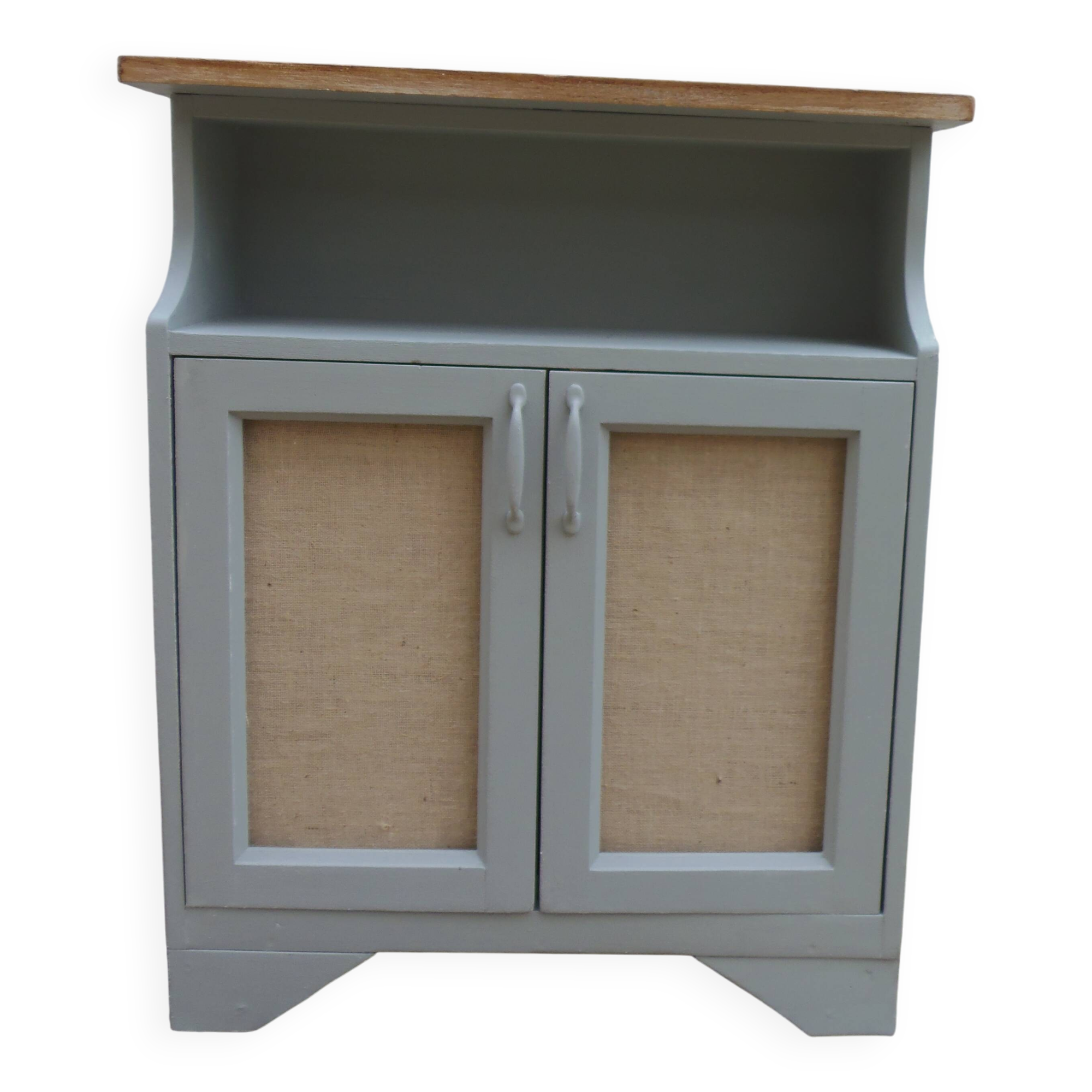 Small vintage green-grey piece of furniture, with 2 doors covered in burlap.