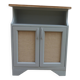 Small vintage green-grey piece of furniture, with 2 doors covered in burlap.