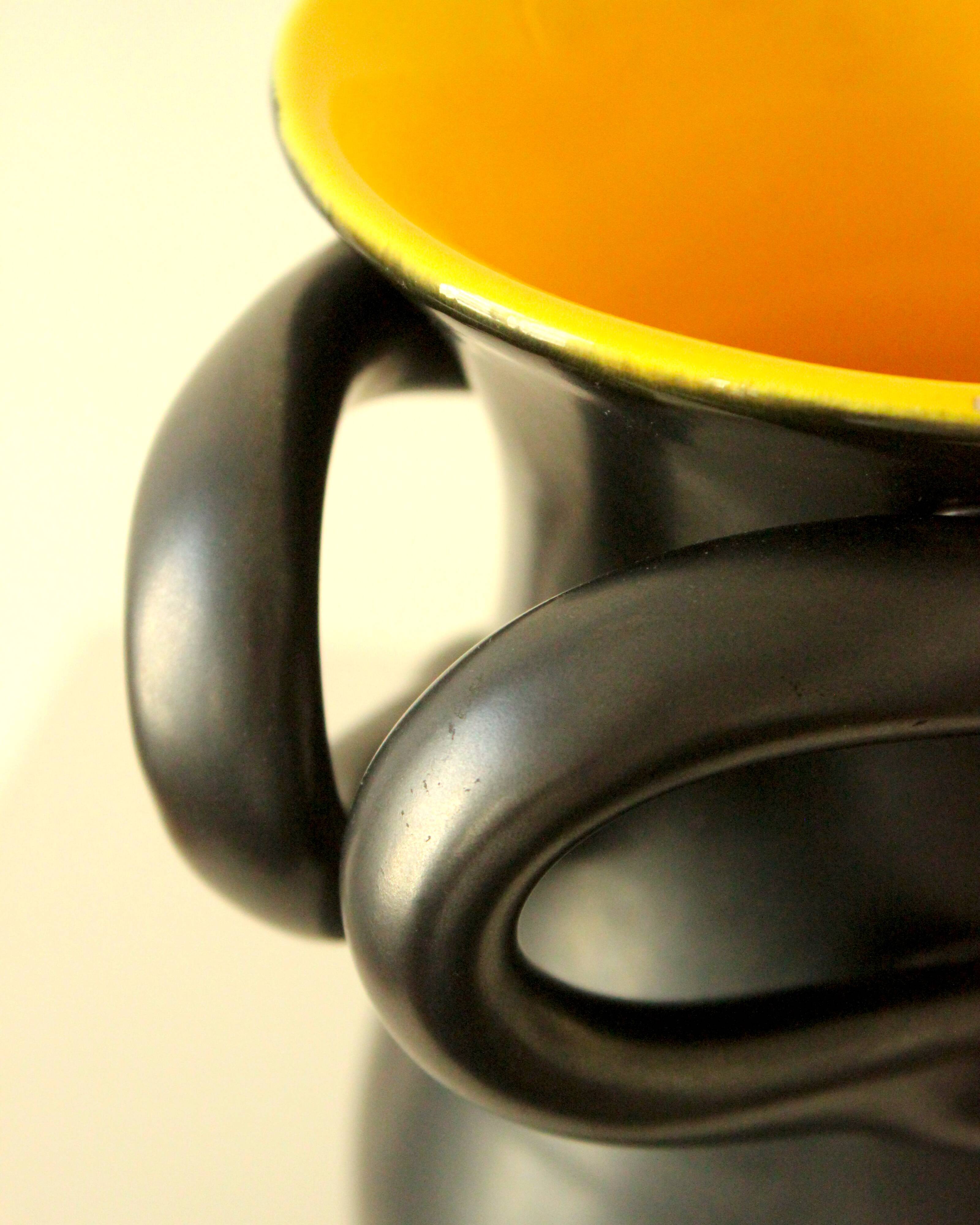Glazed ceramic vase in black and yellow, in the style of Pol Chambost.