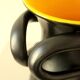 Glazed ceramic vase in black and yellow, in the style of Pol Chambost.
