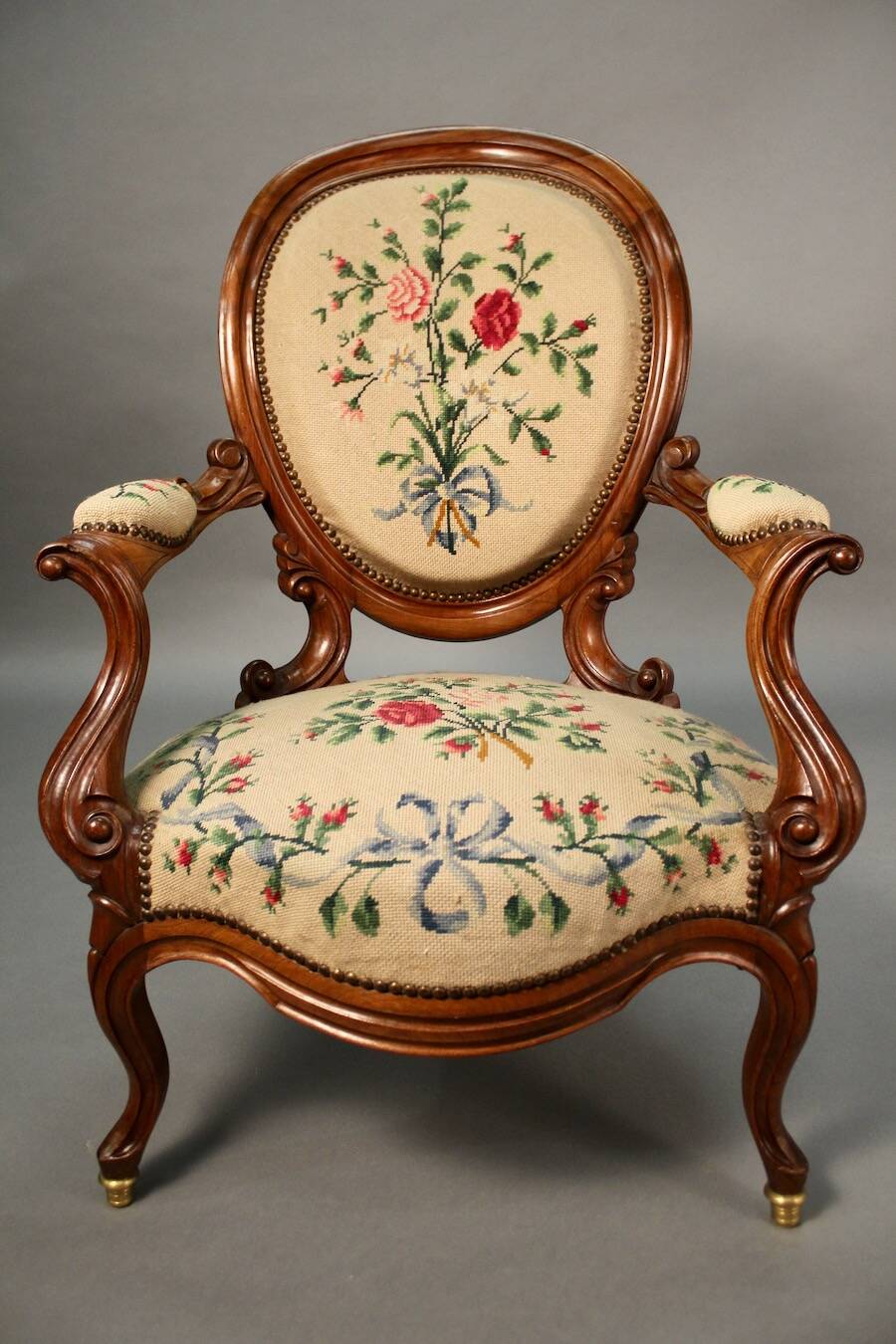 Pair of Louis Philippe armchairs with petit point upholstery.