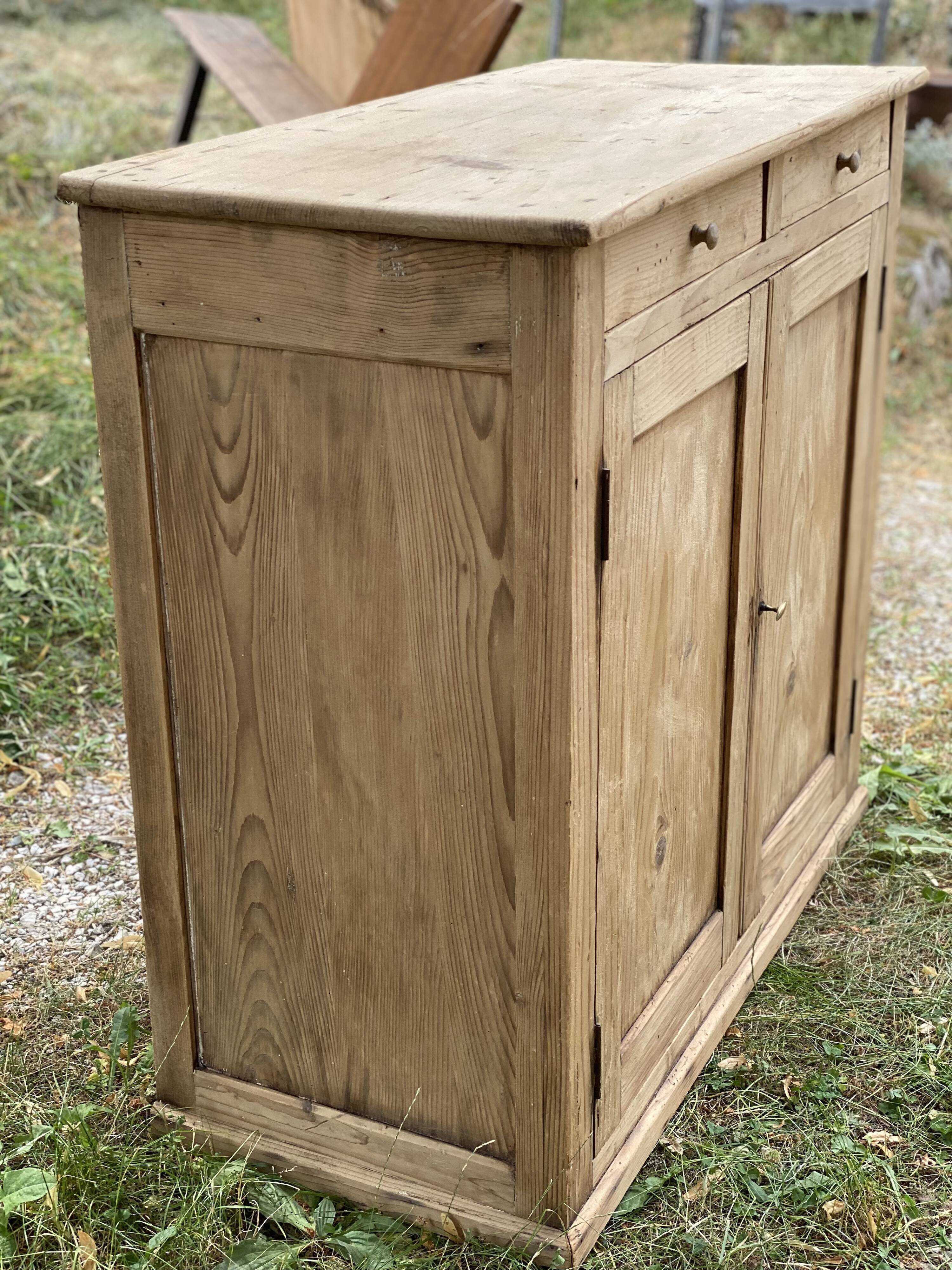 Small Parisian buffet with 2 doors and 2 drawers in light wood.