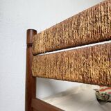 Brutalist style bed with chain and straw