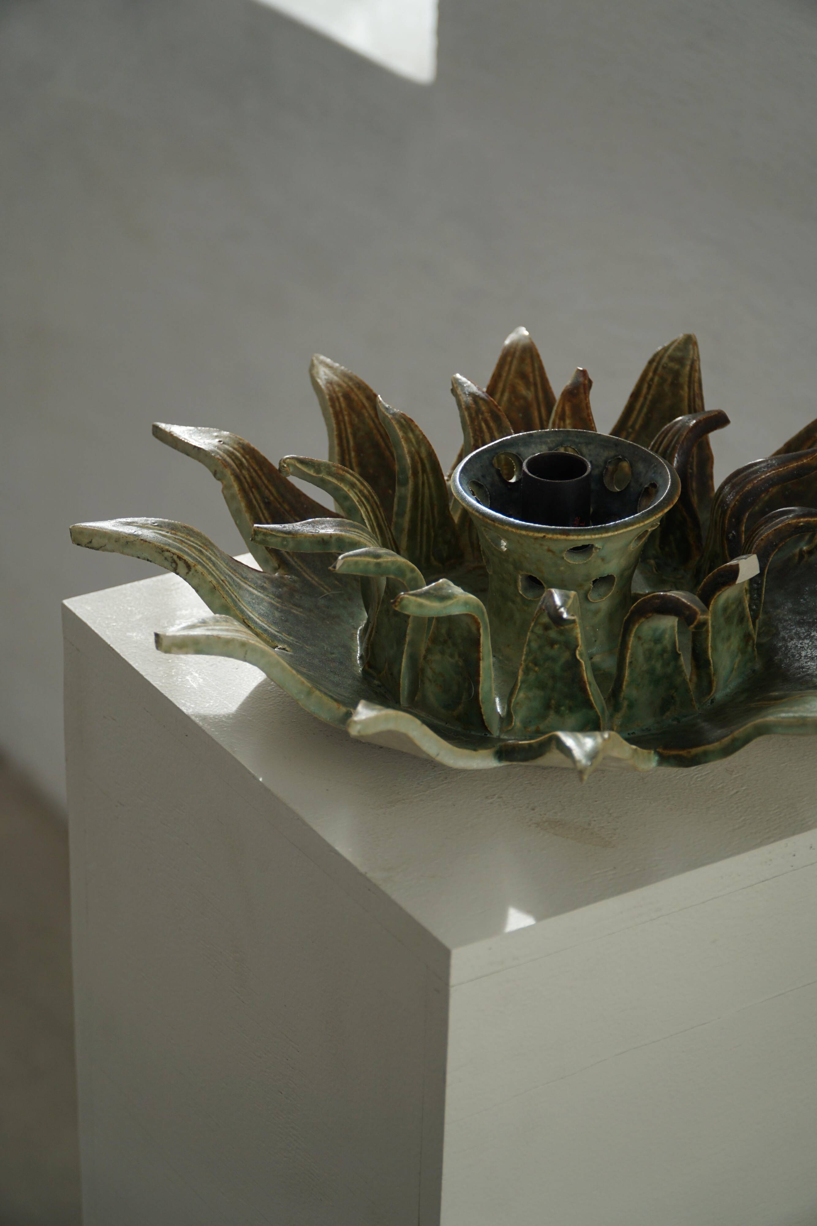 Wall lamp or decorative wall sculpture in ceramic in the shape of a sun, mid-20th century, 1960.