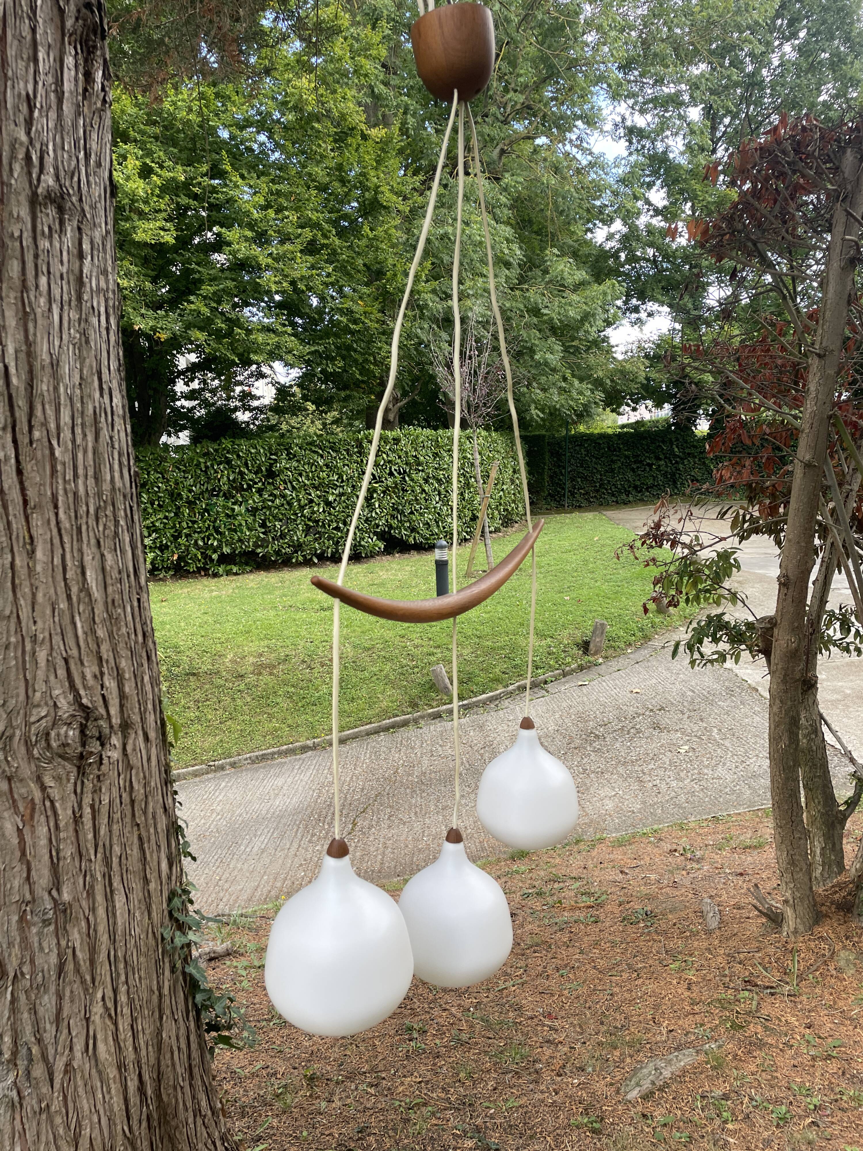 Scandinavian triple pendant light in Opaline and oak by Uno & Östen Kristiansson.