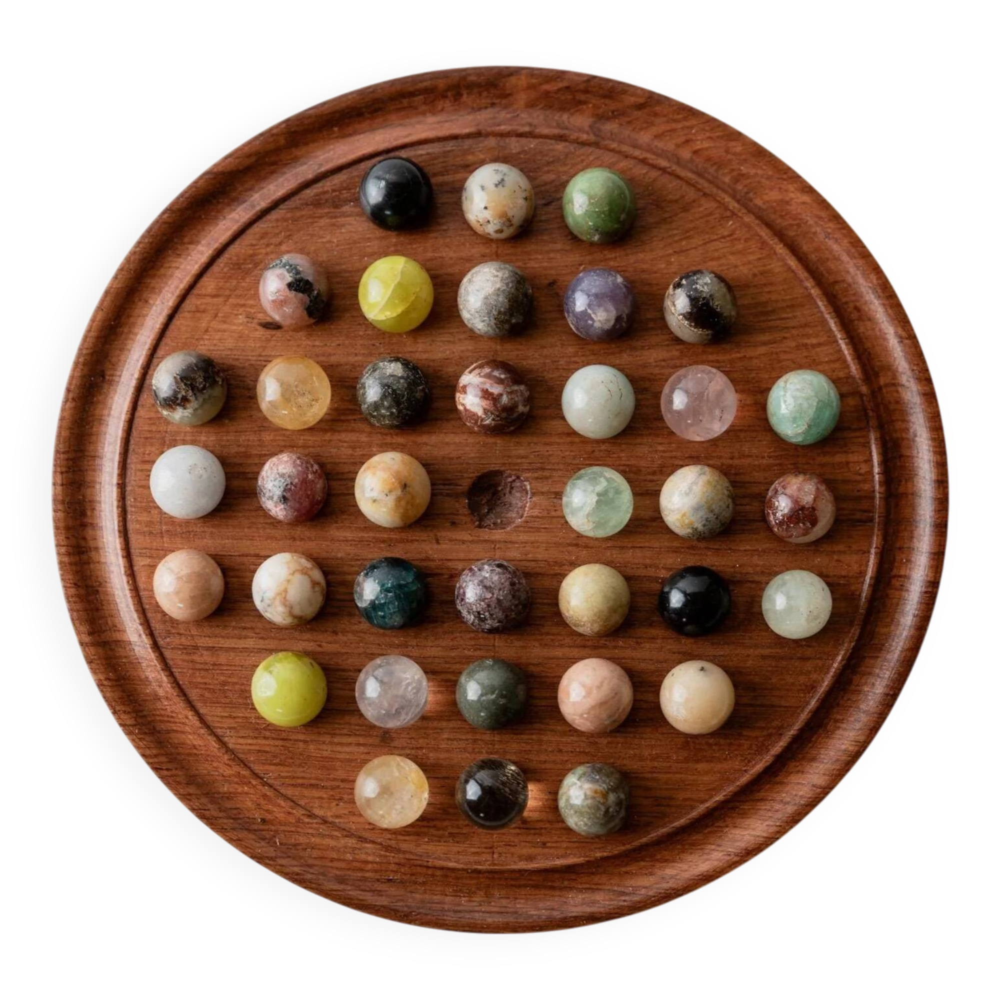 Vintage 1960s solitaire game, wooden board with stone marbles.