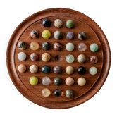 Vintage 1960s solitaire game, wooden board with stone marbles.