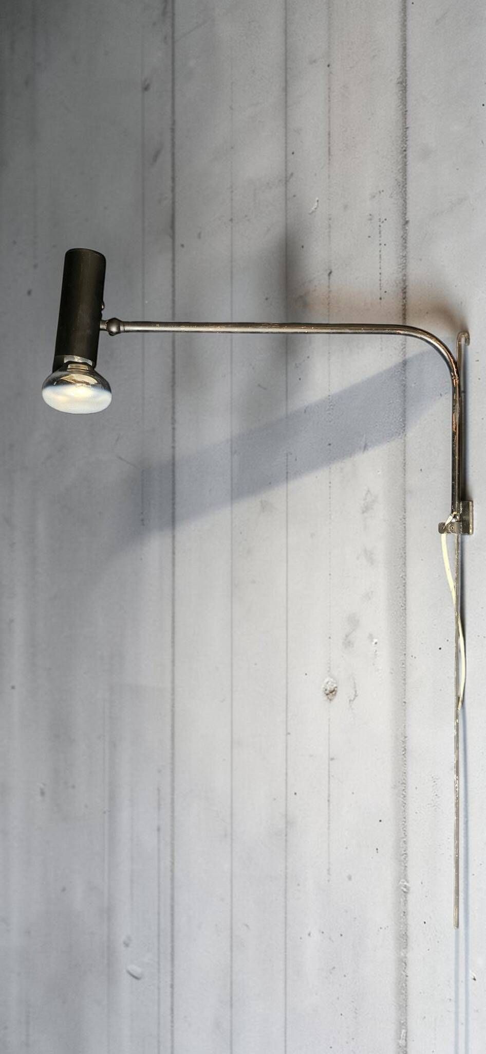 Minimalist metal wall light in the style of Jean Prouvé, circa 1950.