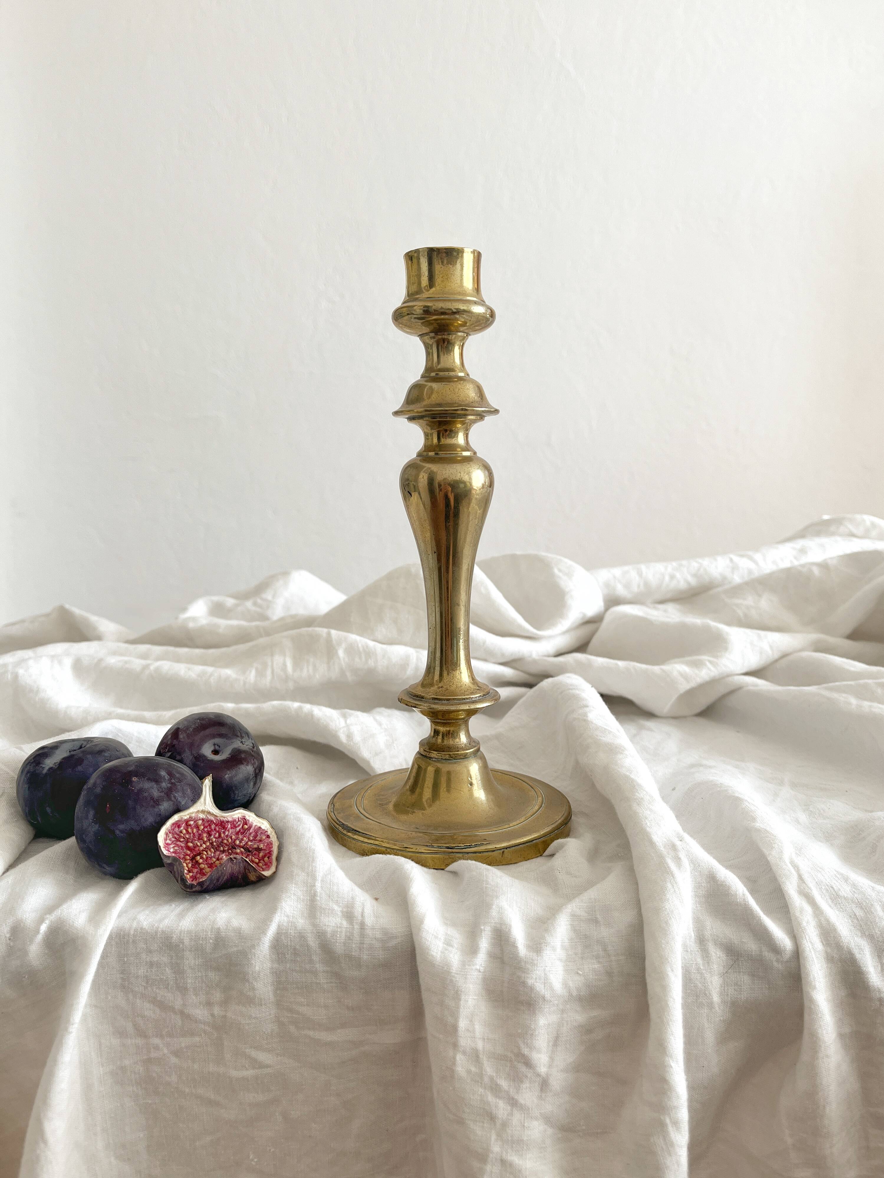 Antique brass candlestick in vintage baluster shape