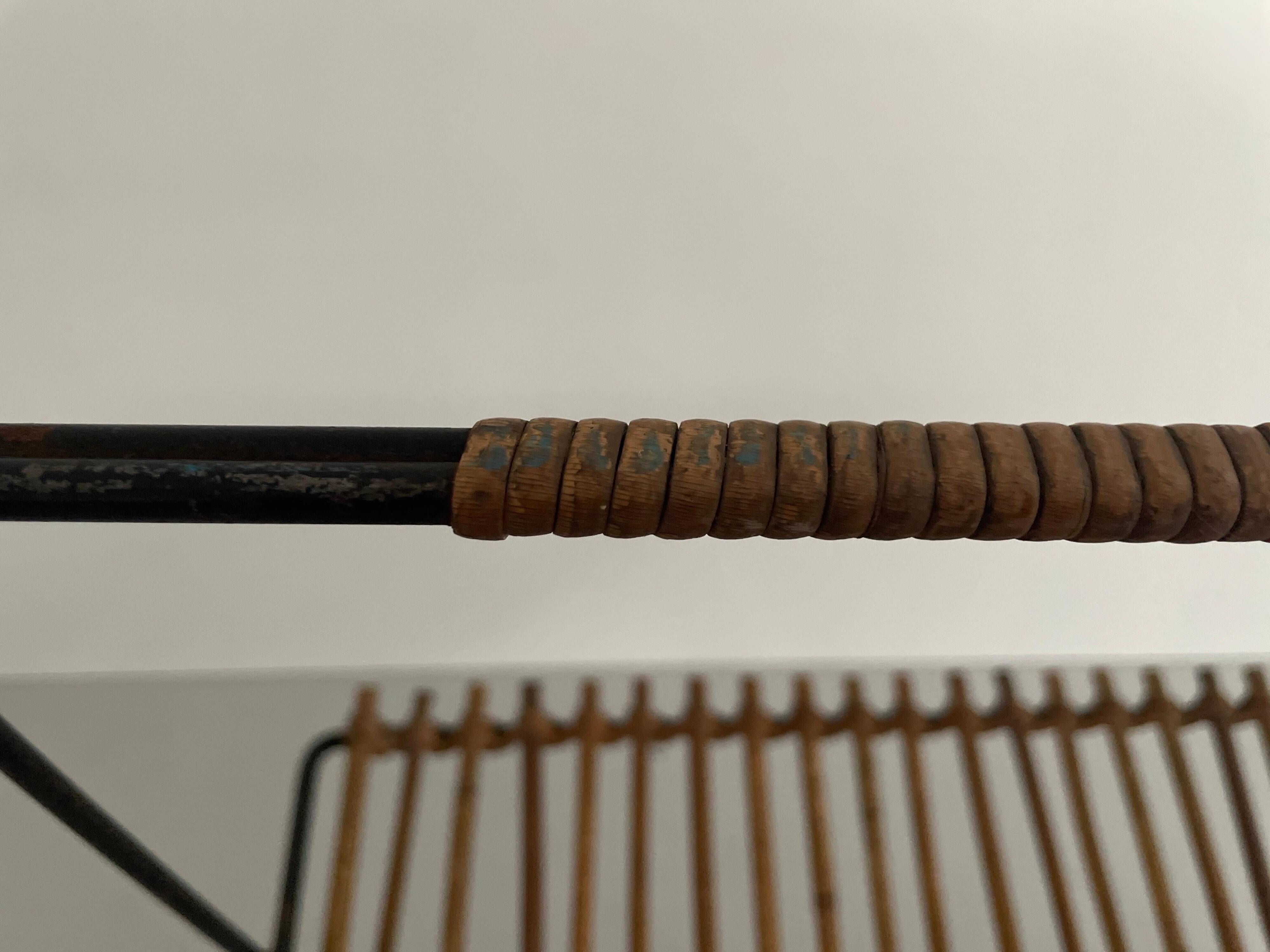 Mid-century black metal and rattan magazine rack, 1960, Italy