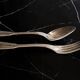 24 silver-plated metal table settings in the filet model.