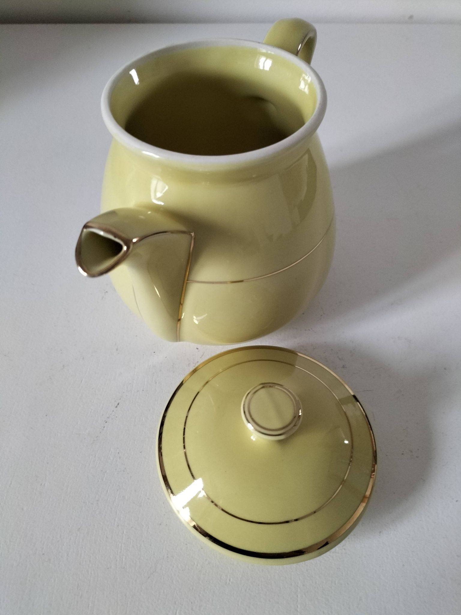Vintage teapot in pastel yellow earthenware with gold trim