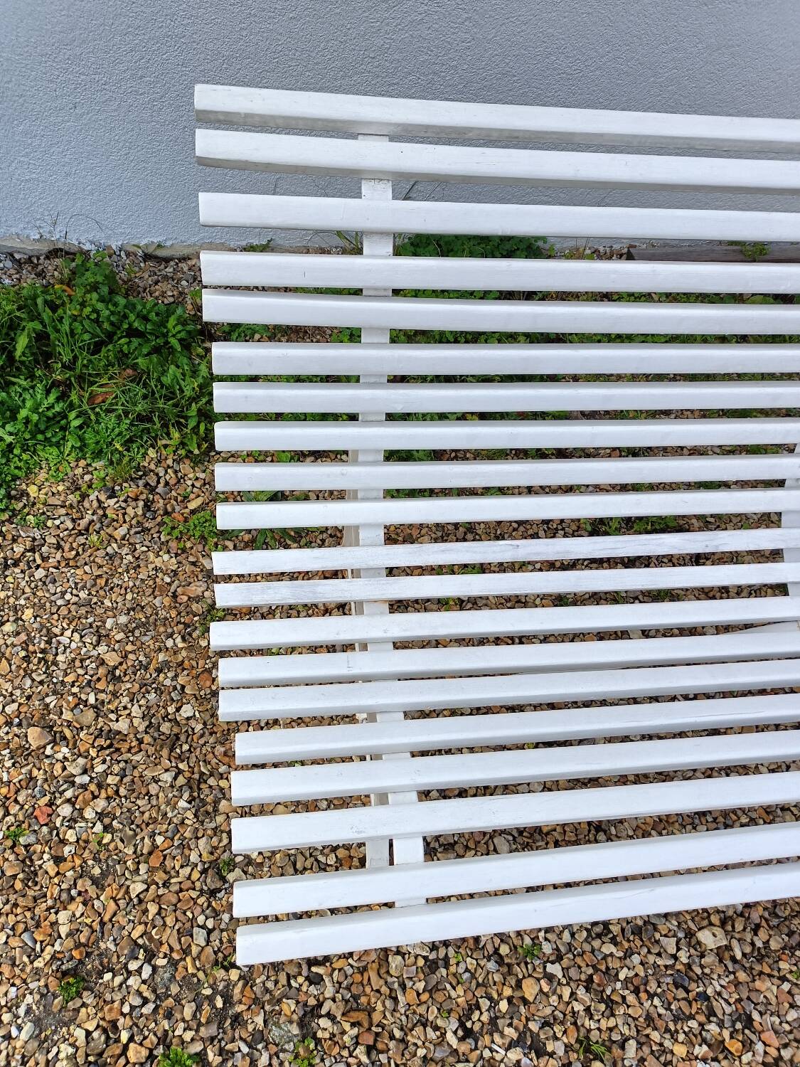 Old garden bench with metal legs and wooden slats