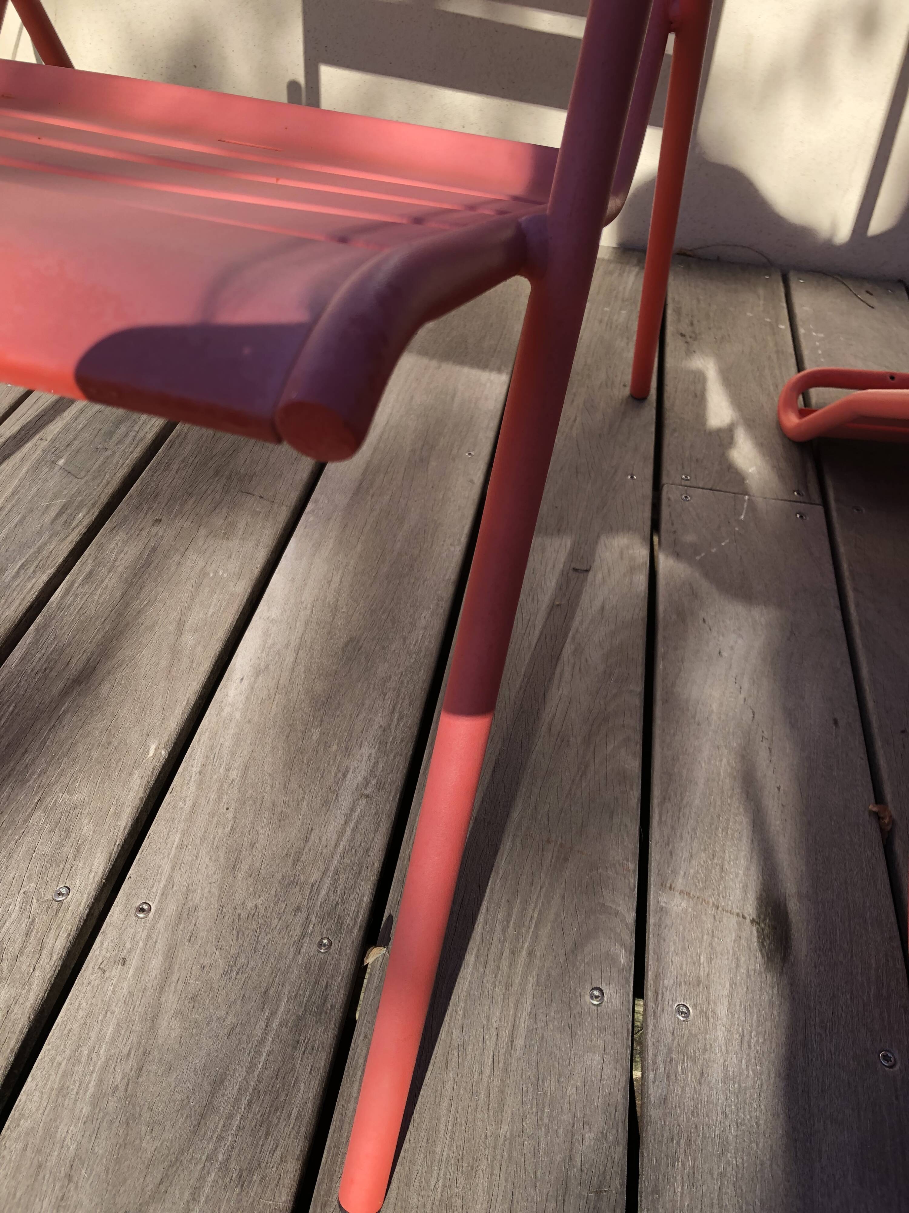 2 low chairs Fermob model Monceau in capucine colour.