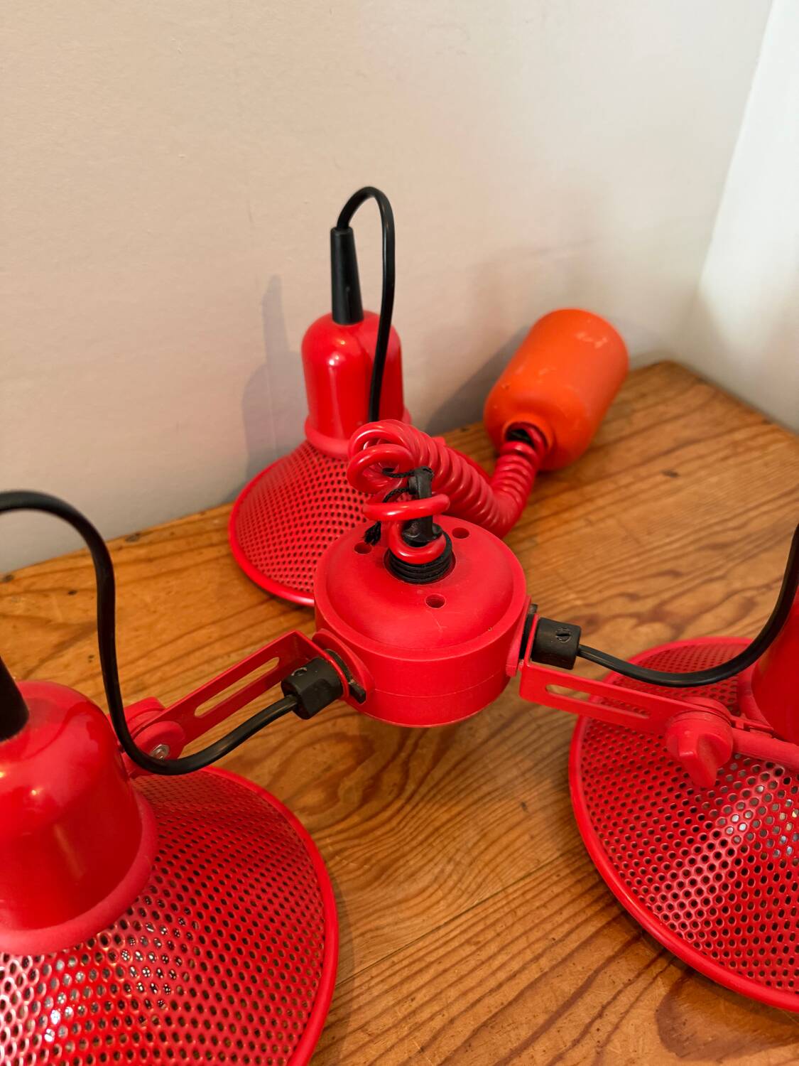 Three-lamp suspension in Memphis design style in red metal.